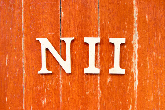 Alphabet letter in word NII (Abbreviation of Net interest income) on old red color wood plate background