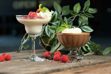 Raspberry Panna Cotta and chocolate mousse isolated on the wooden table