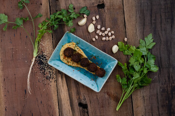 Bite sized falafel of chickpea, onion, sesame seeds served with a garlic hummus dip isolated on rustic wooden table
