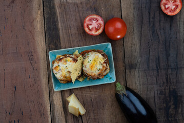 Top view of pan fried crispy eggplant with parmesan cheese crust isolated on wooden table