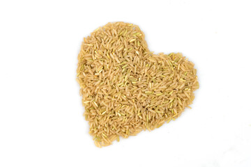 Brown rices arranged heart shape isolated on white background.