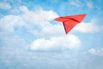 Paper plane flies in the cloudy sky. Travel concept, business success. Copy space. Travel, business,