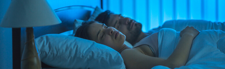 The sleeping man and woman on the bed. night time