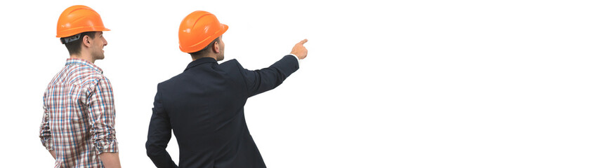 The two engineers gesture on the white wall background