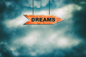 Dreams. Wooden signpost in the cloudy sky. Business. Lifestyle.