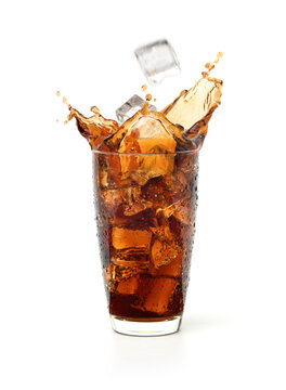 Glass of cool cola splash with ice falling isolated on white background.