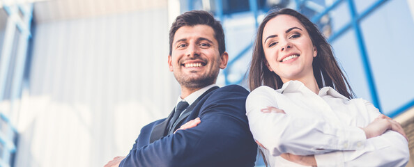 The smile man and woman stand on the background of the office center