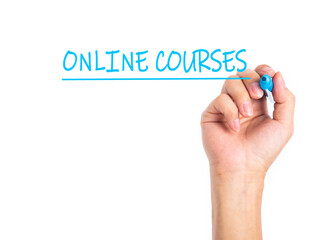 Man hand writing ONLINE COURSES on a transparent wipe board.