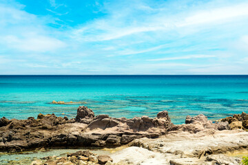 Fototapeta na wymiar (Selective focus) Stunning view of a coastline bathed by a turquoise, clear sea. Rena Majore is a small seaside village that's located south of Santa Teresa Gallura, Sardinia, Italy.