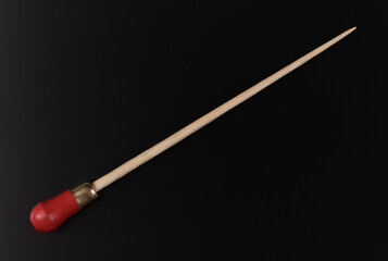 conductor stick isolated on black background