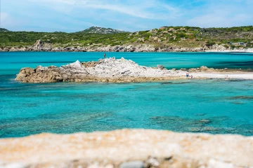 Gordijnen (Selective focus) Stunning view of a coastline bathed by a turquoise, clear sea. Rena Majore is a small seaside village that's located south of Santa Teresa Gallura, Sardinia, Italy. © Travel Wild