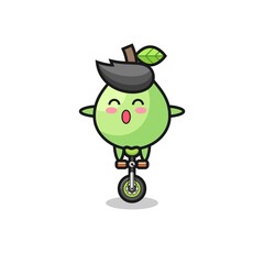 The cute guava character is riding a circus bike
