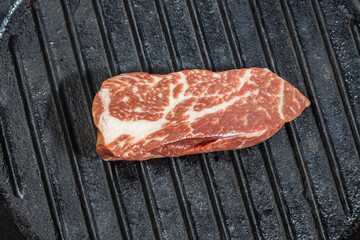 Fry beef meat in a cast iron grill pan