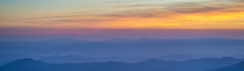 The picturesque mountain landscape on the sunset background
