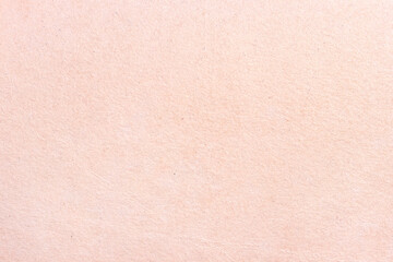 The surface of an old worn cardboard sheet. Light paper neutral texture.