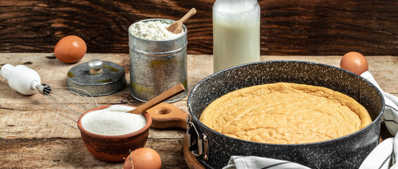 Homemade sponge cake or chiffon cake with ingredients on wooden table. Bakery background concept. banner, menu recipe place for text