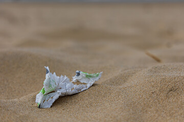 Close up of paper litter on the beach