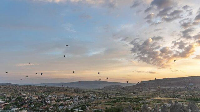 Beautiful scenic morning landscapes of Cappadocia, Goreme, Turkey. 4k time lapse video footage of colorful hot air balloons flying at sunrise time. View at flying hot air balloons from top of mount