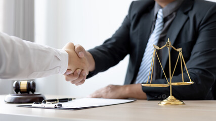 Businessman shaking hands with a lawyer or judge After signing the contract and the agreement is...