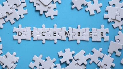 DECEMBER word written on white jigsaw puzzle
