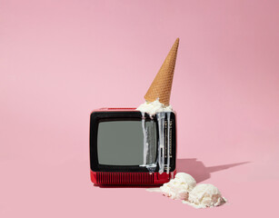 Creative composition with old tv and ice cream cone up side down melting and two vanilla ice cream...