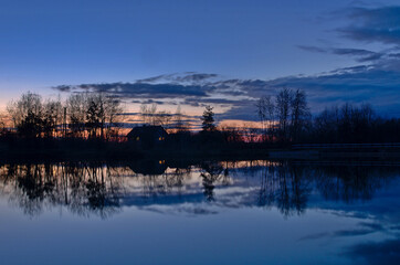 Fototapeta na wymiar House on the lagoon in the evening time.
