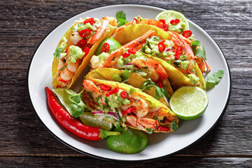 taco shells with shrimps on a plate