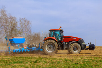 modern combine harvester works in the field. Sowing and harvesting.