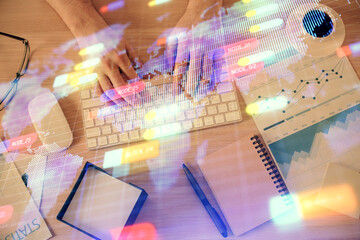 Double exposure of man's hands typing over computer keyboard and data theme hologram drawing. Top view. Technology concept.