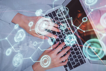 Double exposure of woman hands working on computer and social network theme hologram drawing. Top View. People connection concept.