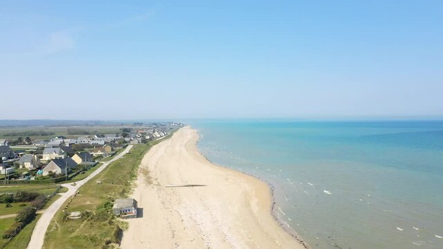 The large sandy Utah beach and a bunker in Europe, France, Normandy, towards Carentan, in spring, on a sunny day.