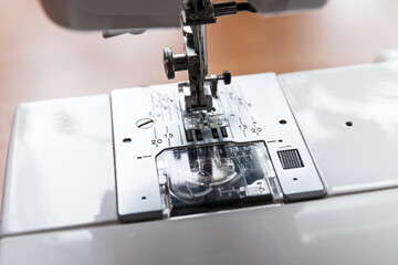 Production line sewing machine. Needle and footstep detail