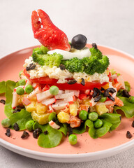 Russian salad with crab meat on a plate