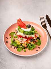 Russian salad with crab meat on a plate