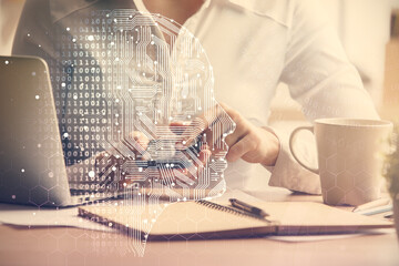 Double exposure of brain sketch hologram and woman holding and using a mobile device.