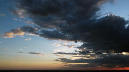 Beautiful contrasting clouds in the sky at sunset. Background for design