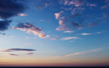 Beautiful contrasting clouds in the sky at sunset. Background for design