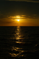 sunset in the middle of the sea with silhouette of the ocean