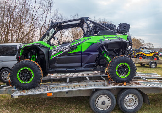 Afipsip, Russia - October 31, 2020: Green Kawasaki Teryx buggy on trailer ready for Mud Racing contest. ATV SSV motobike competitions are popular extreme sport and outdoor activity.