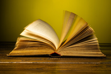 open book on a table on a gradient background with page turning