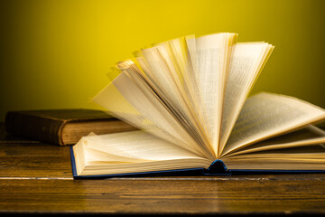 open book on a table on a gradient background with page turning