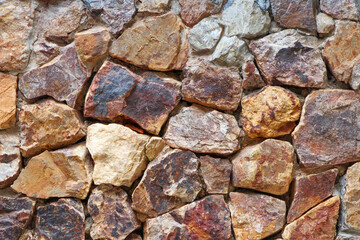 Rock wall with different sizes and colors.