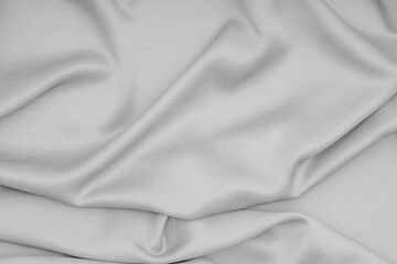 Gray cloth, silk, fabric surface with soft waves of gray fabric texture background.