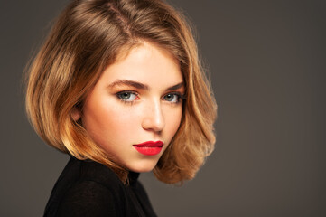 Closeup portrait of an young adult girl with medium length hair.  Photo of a fashion model posing...