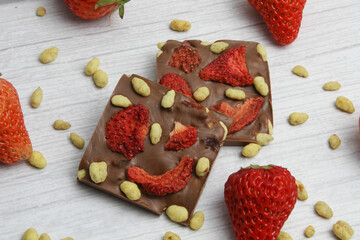 Hand made chocolate with freeze-dried strawberry and pine nuts