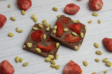 Hand made chocolate with freeze-dried strawberry and pine nuts
