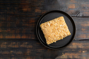 Layered cake with cream Napoleon millefeuille vanilla slice on dark background