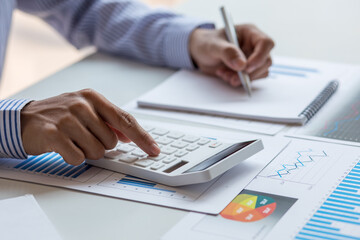 Financial Business man analyze the graph of the company's performance to create profits and growth,...