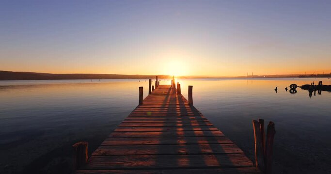 Sunset over the lake and old fishing dock