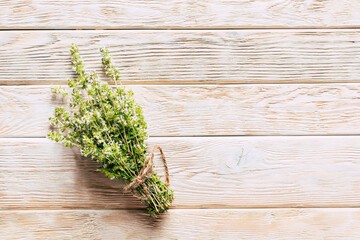 Bunches of fresh thyme on wooden background